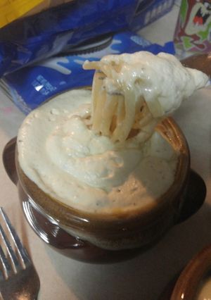 A picture of Noodle soup with cream sauce.