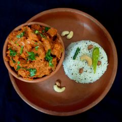 A picture of Kacha kela masala fry with coconut rice.