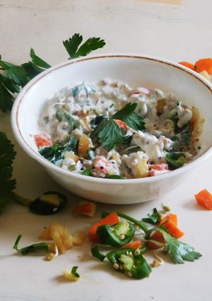 A picture of A healthy breakfast-Fermented Farro with curd, sprouts, and veggies.