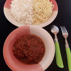 A picture of Rice and spaghetti with fish soup.
