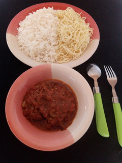 A picture of Rice and spaghetti with fish soup.