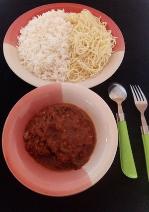 A picture of Rice and spaghetti with fish soup.