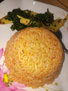 A picture of Jallof rice with spinach.