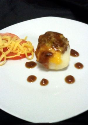 A picture of Baked patato with brown onion sous.