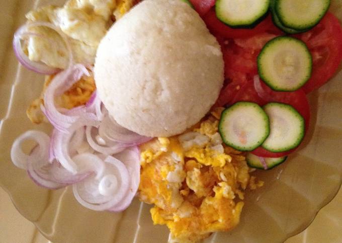 Ugali served with omlete and kachumbari