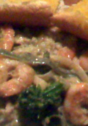 A picture of seafood alfredo with chicken.
