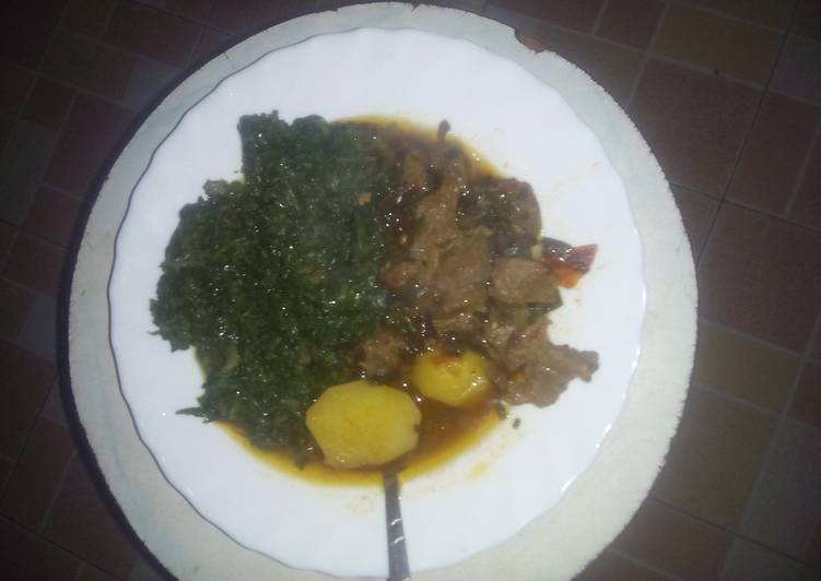 Beef stew served with greens