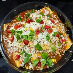 A picture of Cheesy vegetable enchiladas.