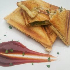 Sauteed vegetable sandwich toasted sesame seeds and tomato sauce A picture of Sauteed vegetable sandwich toasted sesame seeds and tomato sauce.