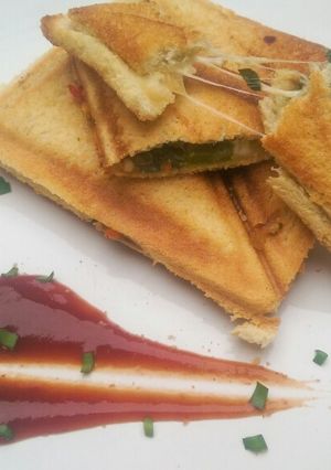 A picture of Sauteed vegetable sandwich toasted sesame seeds and tomato sauce.