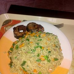 A picture of Indomine with carrots,Green peas and fish.