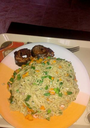 A picture of Indomine with carrots,Green peas and fish.
