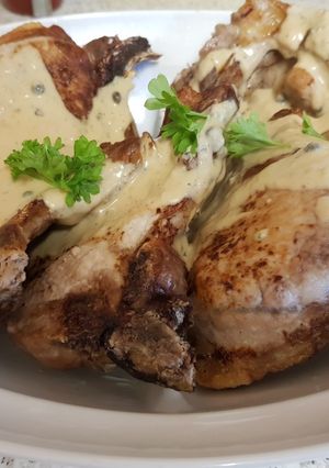 A picture of Pork Chops with peppercorn sauce.