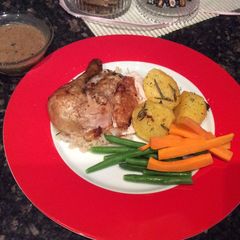 A picture of Roast Chicken with deep fried potatoes.