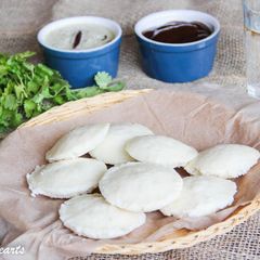 A picture of Idli-South Indian soft pillowy steamed lentil rice cakes.