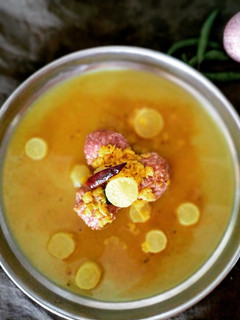 A picture of Ragi Mudde with brown rice and moolangi sambar.