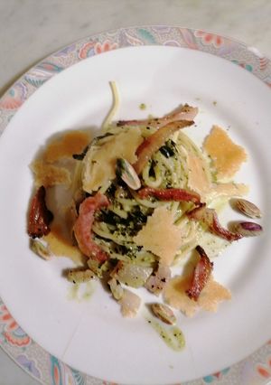 A picture of Spaghetti with Guanciale, Tuscan Kale Pesto, Pistachios, and Parmesan Crisps.