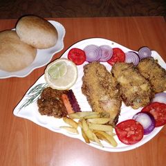 A picture of Baked fish 🐠🧄🧅🍋🍅.