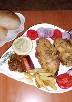 A picture of Baked fish 🐠🧄🧅🍋🍅.