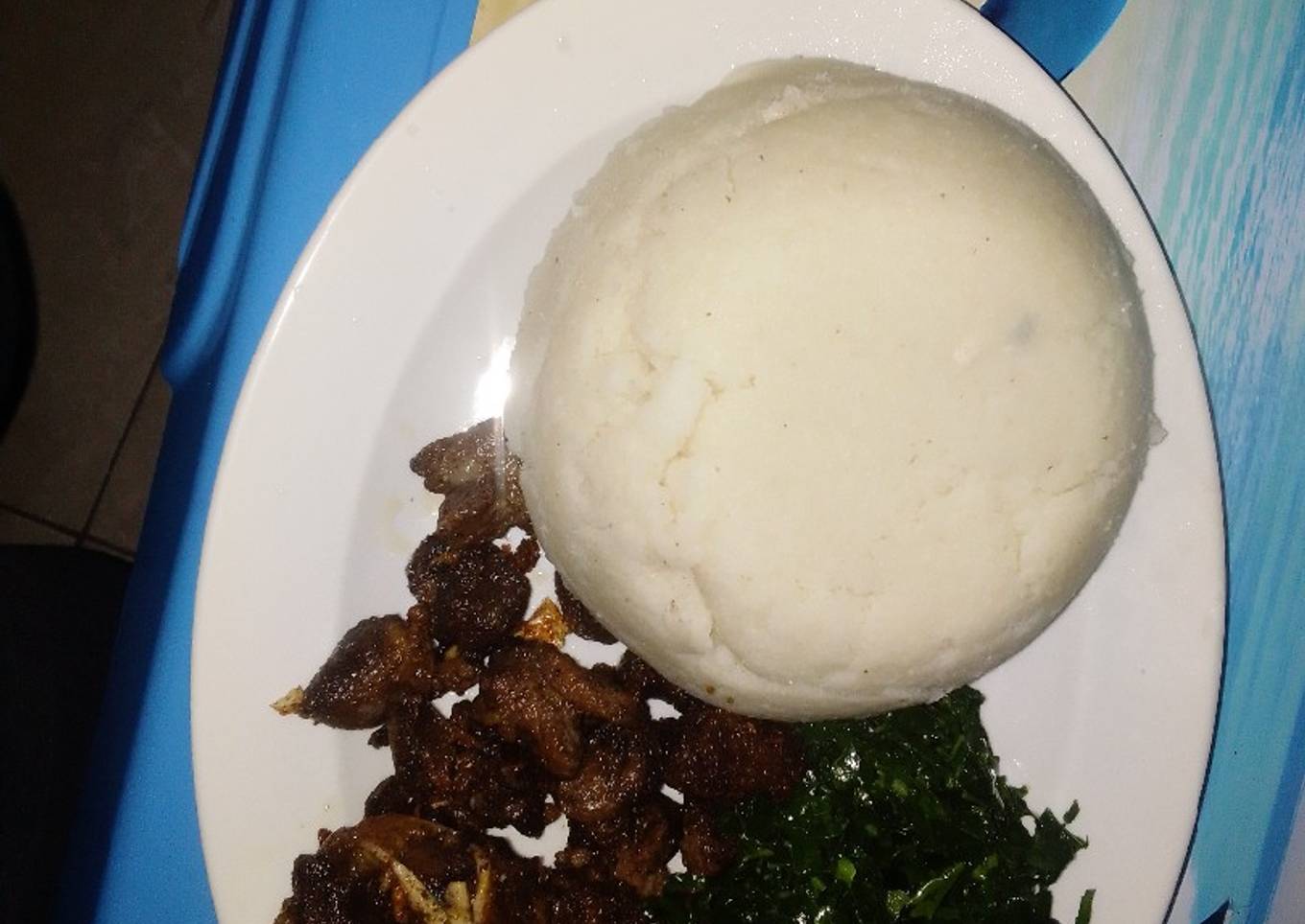 Pan Fried goat meat served with kales