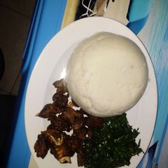 Pan Fried goat meat served with kales A picture of Pan Fried goat meat served with kales.