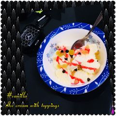 A picture of Vanilla ice cream with chocolate chips & more.