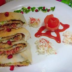 A picture of Carrot cheese pomegranate roll dosa.