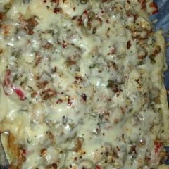 A picture of Pizza Fries with Chicken Chunks.