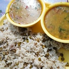 A picture of Dhaba style dal tadka and green chane rice.