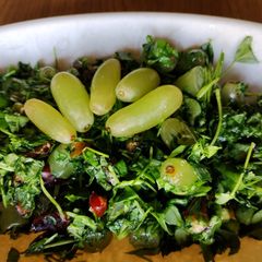 A picture of Grapes + methi leaves salad.