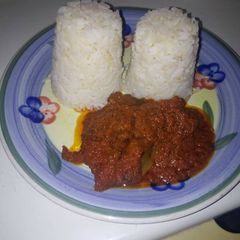 A picture of Twin rice in kpomo and beef sauce.