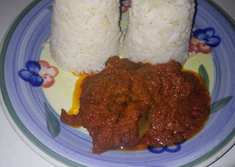 Twin rice in kpomo and beef sauce