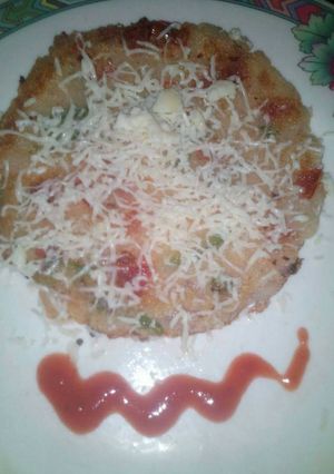 A picture of Cheesy semolina uttapam with italian touch.