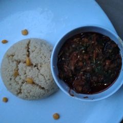 A picture of Cous cous with vegetable soup.