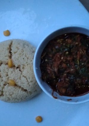 A picture of Cous cous with vegetable soup.