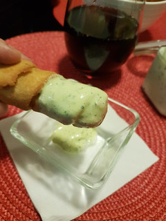 Una foto de Tequeños con salsa verde