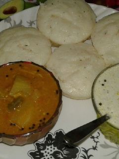 A picture of Rava idli, sambar and coconut chutney.