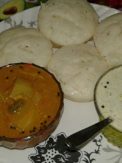 A picture of Rava idli, sambar and coconut chutney.