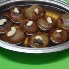 A picture of Ranga   Alur   Ros  Bora // Sweet  Potato  Pakoda  Dip in Sugar Syrup.