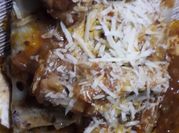 Una foto de tuco con carne para canelones