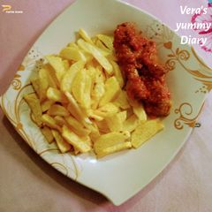 A picture of Fries & sauced chicken.