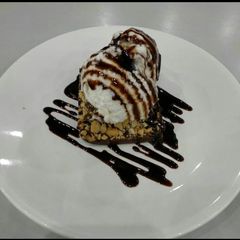 A picture of Rich Chocolate brownie with Roasted nuts & vanilla Icecream.