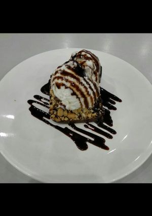 A picture of Rich Chocolate brownie with Roasted nuts & vanilla Icecream.