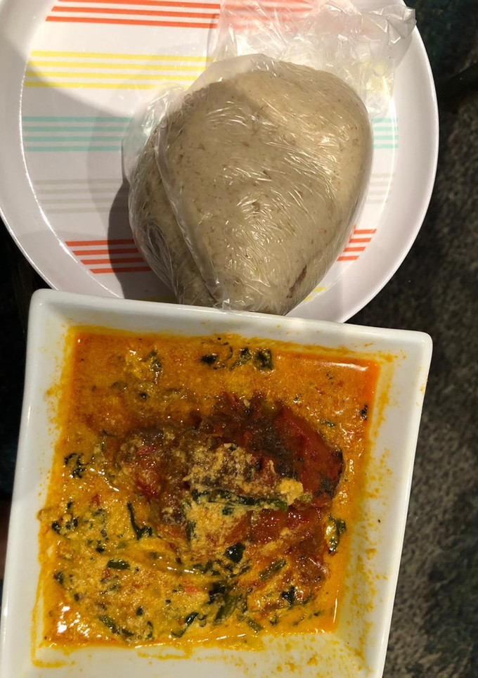 A picture of Egusi soup and cabbage swallow.