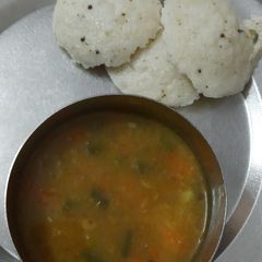 A picture of Sambhar and idli.