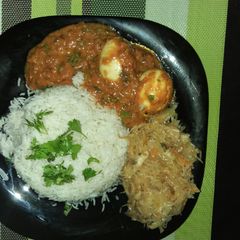 A picture of Rice,Egg Curry and cabbage.