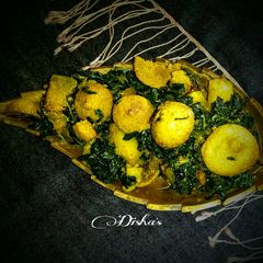 A picture of Jute leaves curry with pumpkin-potato-sundried lentil dumplings.