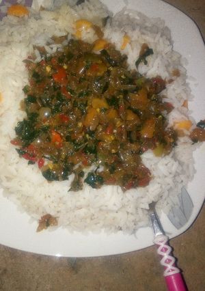 A picture of White rice with ugu soup.