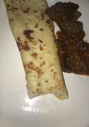 A picture of Pancake with sauced beef.