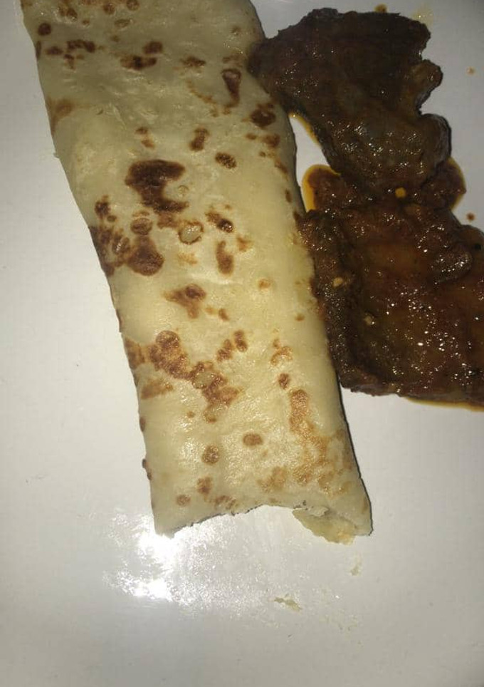 A picture of Pancake with sauced beef.